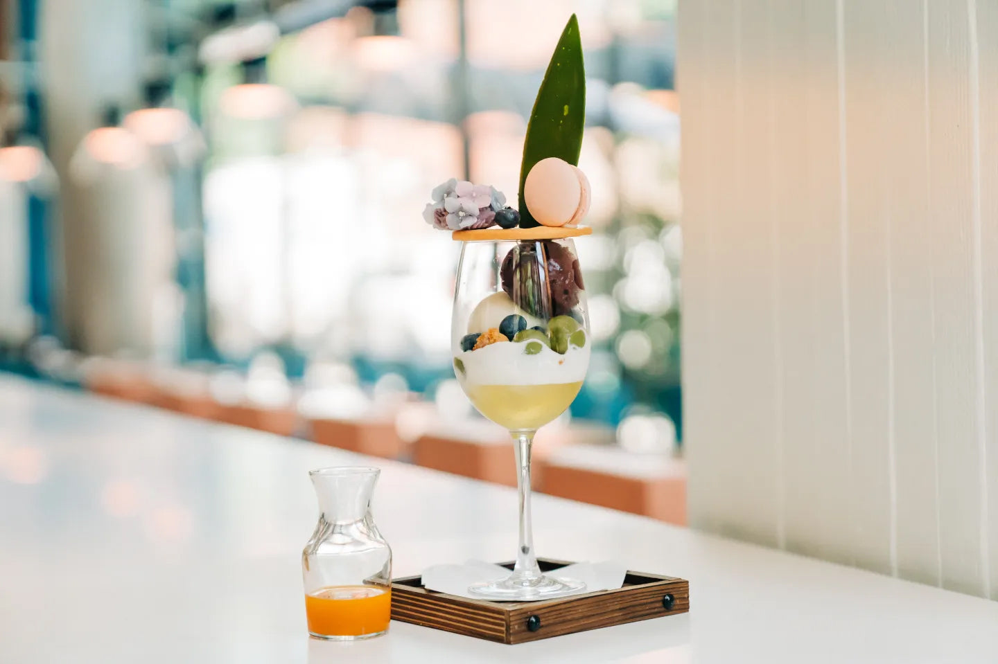 Decorative glass with fruit and a leaf on a blurred background