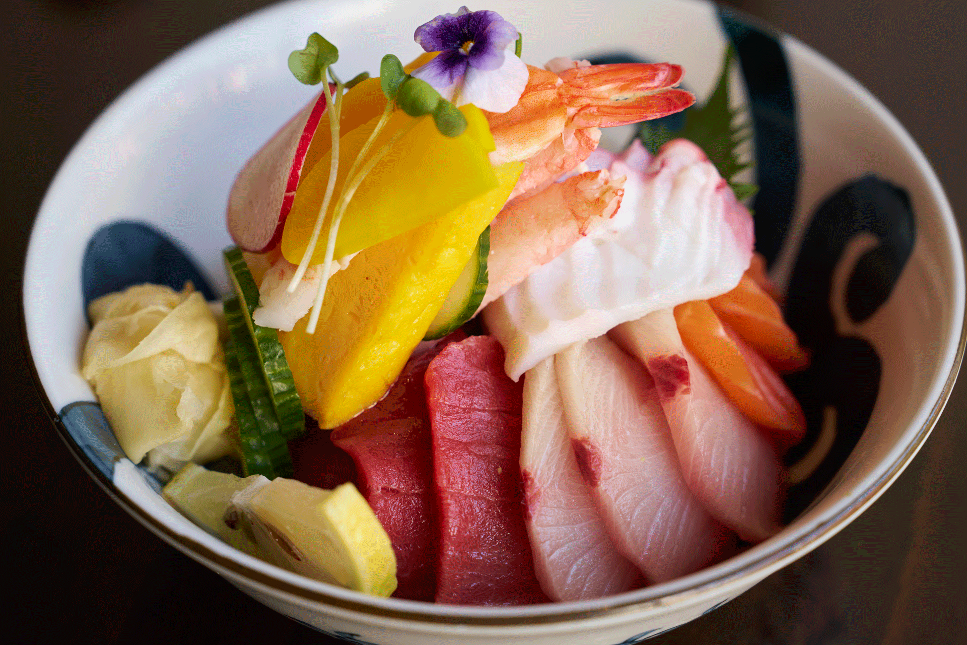 Colorful chirashi sushi bowl with assorted fresh sashimi.