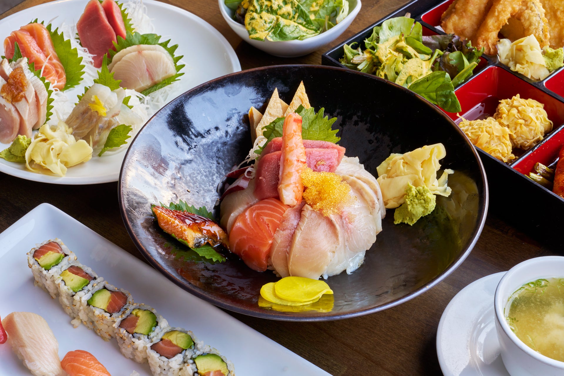 Colorful chirashi sushi bowl with assorted sashimi and vegetables.