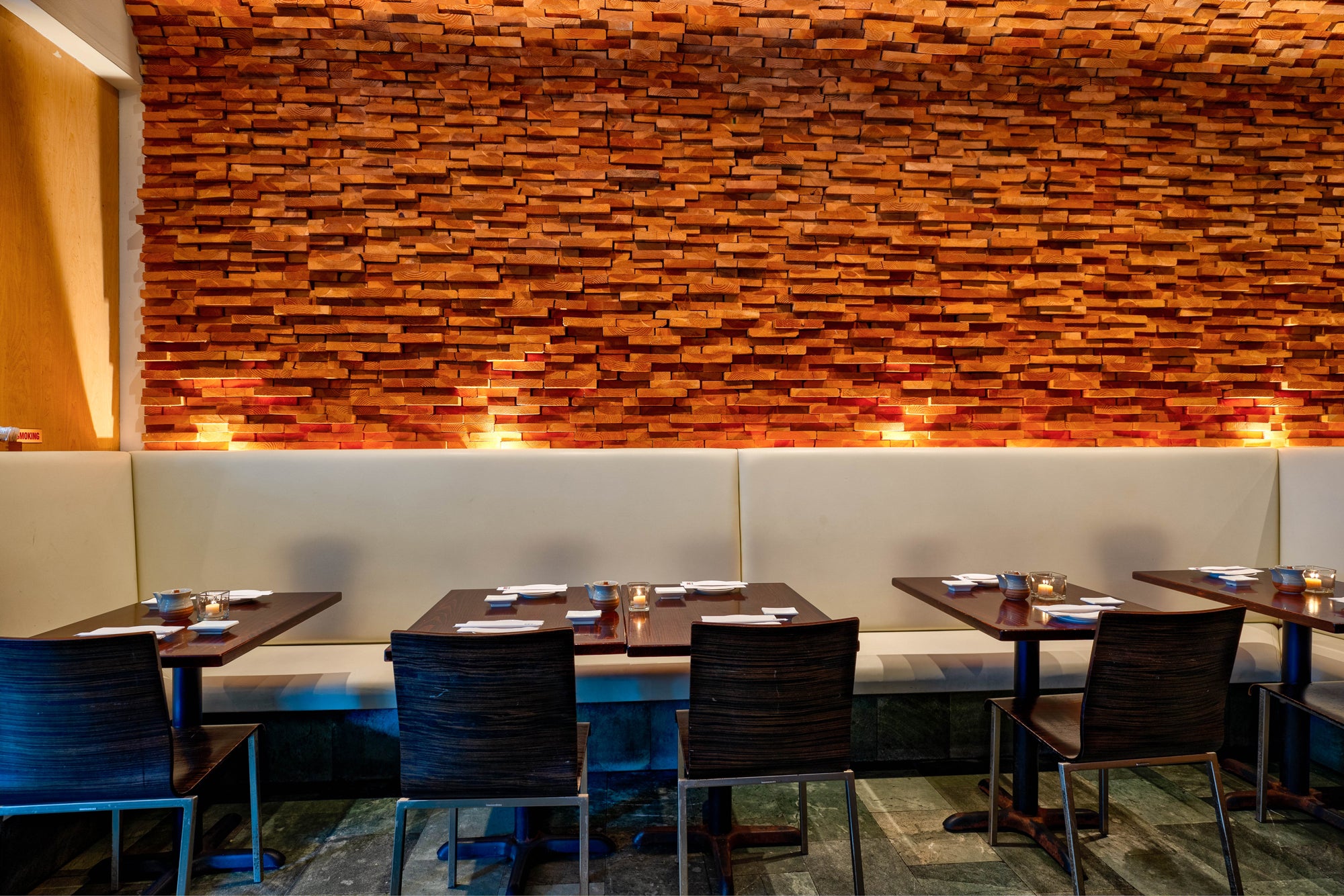 Momoya Upper West Restaurant interior with wooden wall paneling and tables with chairs.