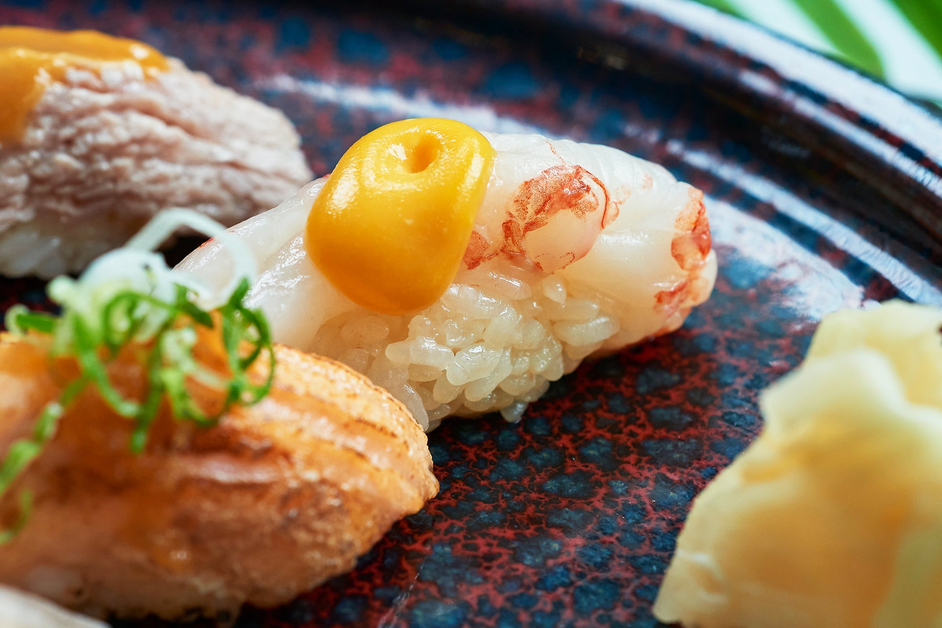 Close-up of sushi with shrimp  on a dark plate